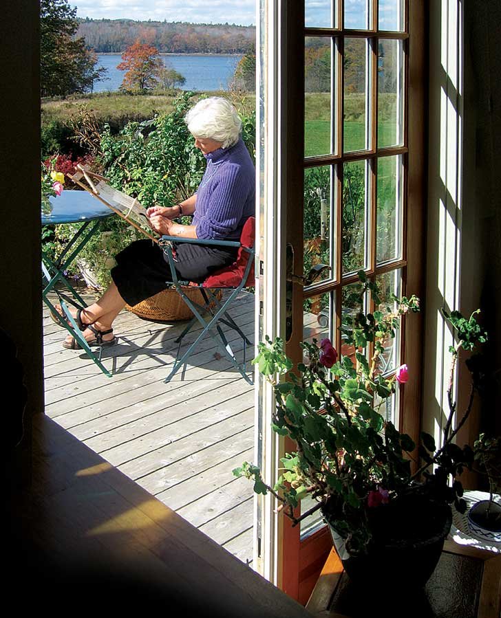 Woman weaving on sunny deck
