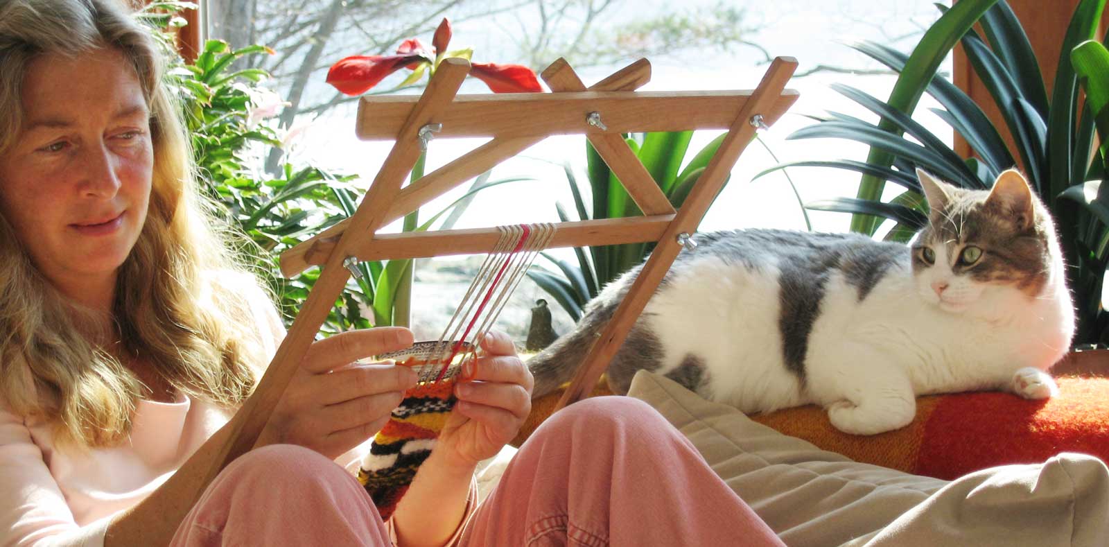 woman weaving on couch with cat