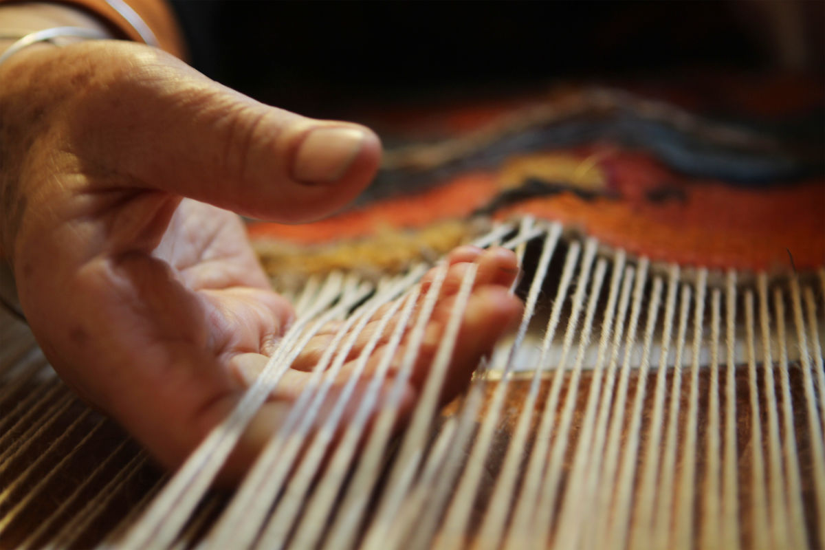 hand with fingers in weaving warp